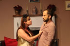 A young woman gripping a man's shirt during an argument