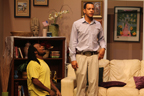 A kneeling man in a yellow T-shirt and a man standing