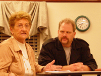 An elderly woman and a man sitting