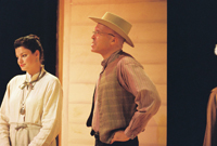 A young woman and a man in a cowbay hat