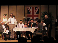 Family sitting at a table with British Flag behind them